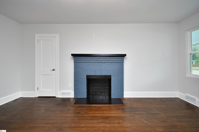 room details featuring hardwood / wood-style floors and a brick fireplace