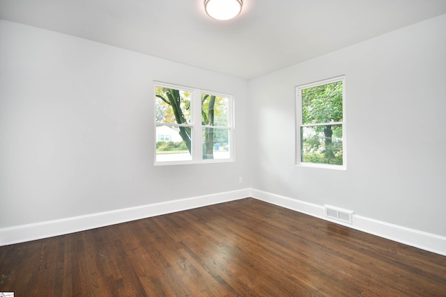 spare room featuring dark wood-type flooring