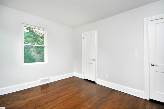 spare room featuring dark hardwood / wood-style flooring