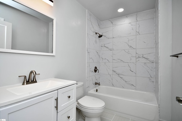 full bathroom featuring tiled shower / bath combo, vanity, and toilet