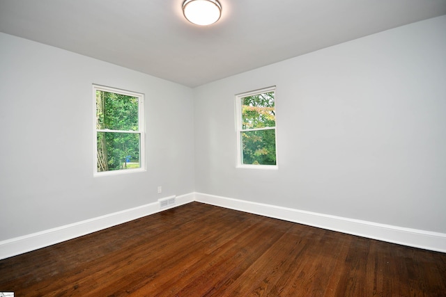 empty room with dark wood-type flooring