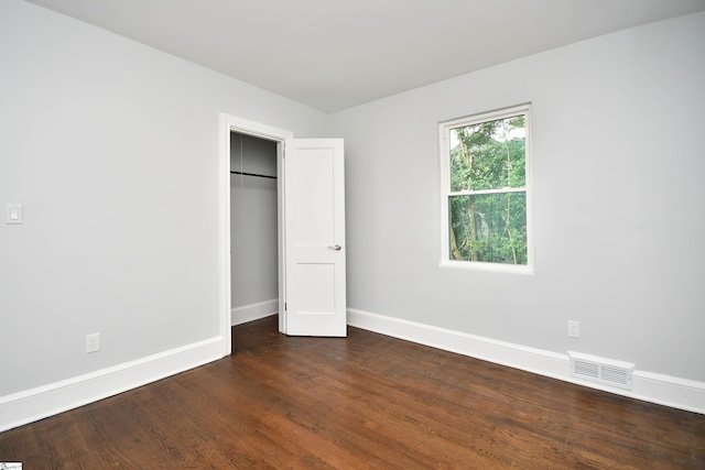 unfurnished bedroom featuring dark hardwood / wood-style flooring