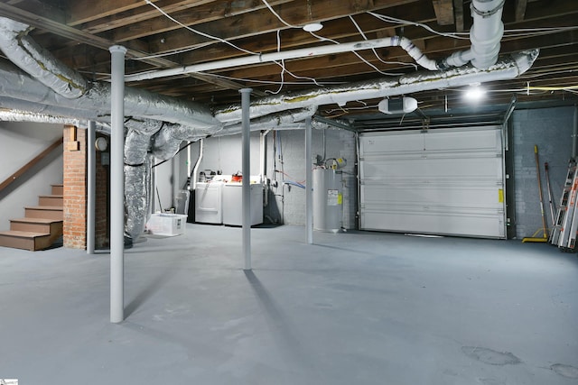 basement featuring water heater and independent washer and dryer