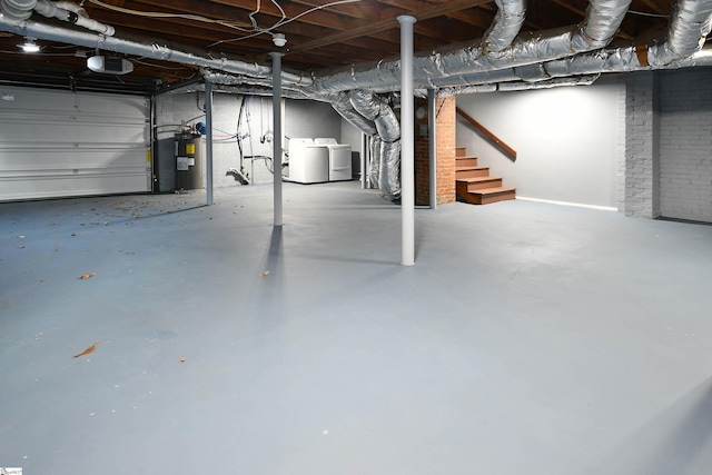 basement with water heater and washing machine and clothes dryer