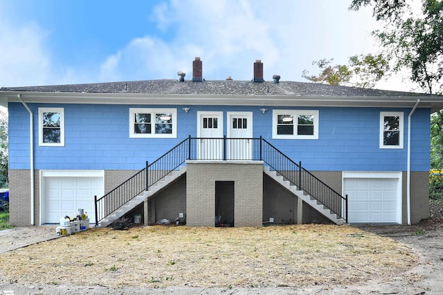 rear view of house featuring a garage