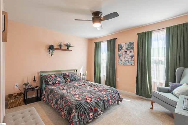 bedroom with ceiling fan and light carpet