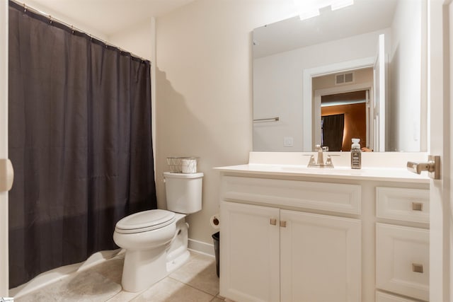 bathroom featuring toilet, vanity, and tile patterned floors