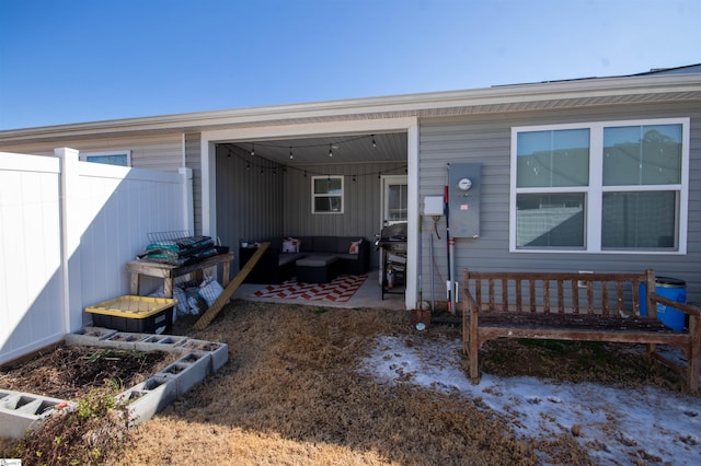 doorway to property with a patio area and outdoor lounge area