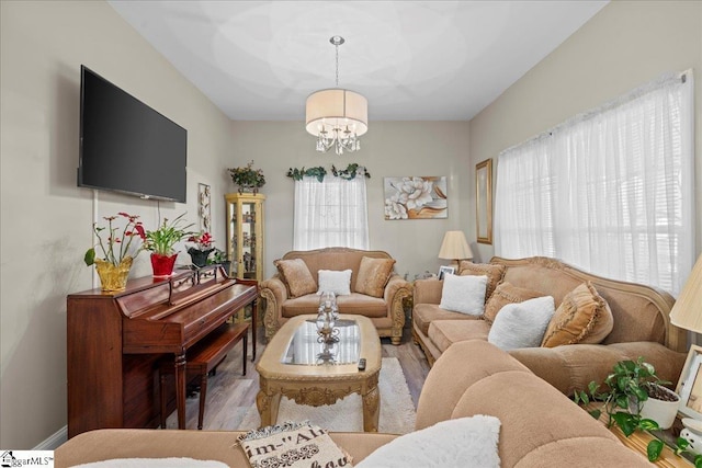 living room with hardwood / wood-style floors and an inviting chandelier