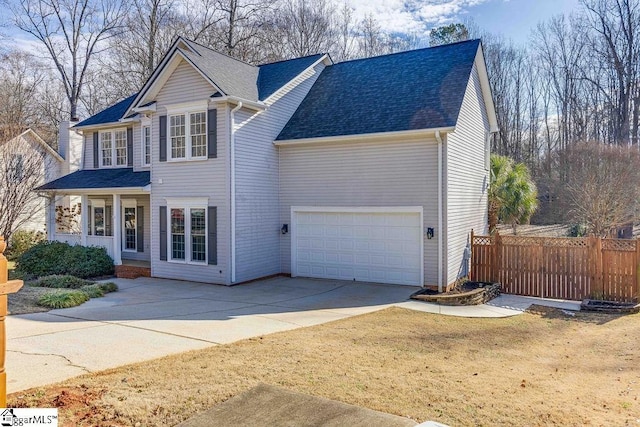 view of front property featuring a porch, a front yard, and a garage