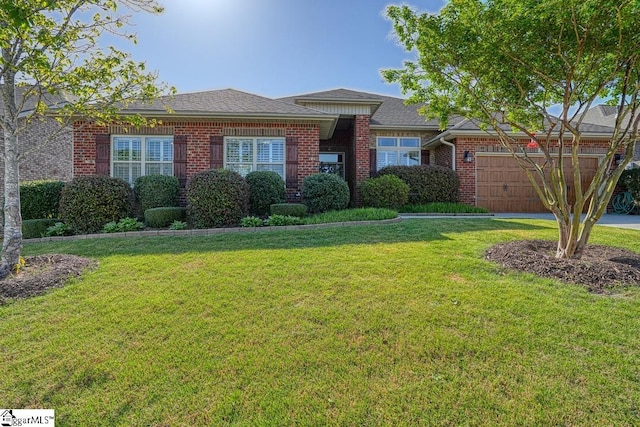 view of front facade with a front yard and a garage