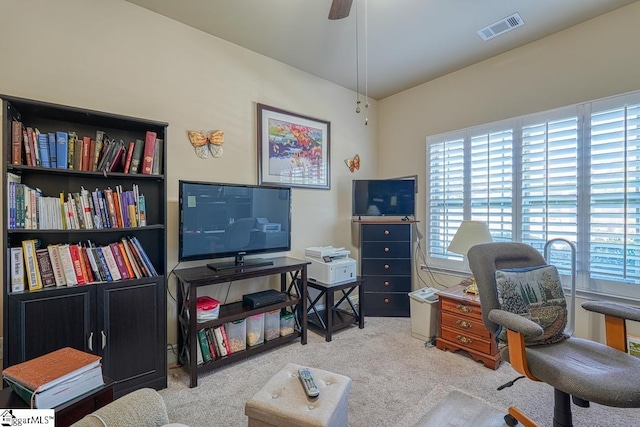 carpeted home office with ceiling fan