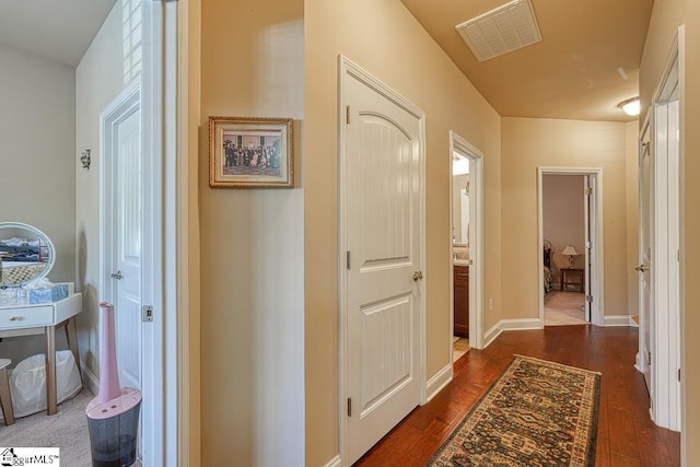 hallway with dark hardwood / wood-style flooring