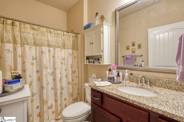 bathroom featuring vanity and toilet