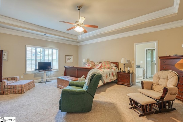 bedroom featuring ceiling fan, crown molding, carpet flooring, and a tray ceiling