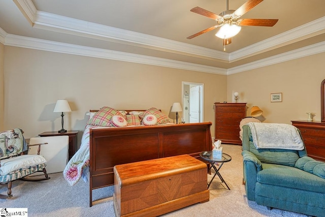 carpeted bedroom with ceiling fan, a raised ceiling, and crown molding