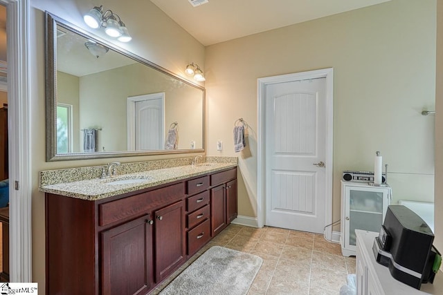 bathroom with tile patterned floors and vanity