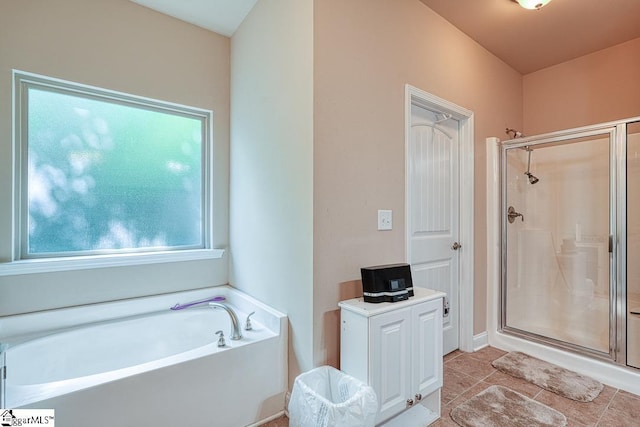 bathroom featuring independent shower and bath