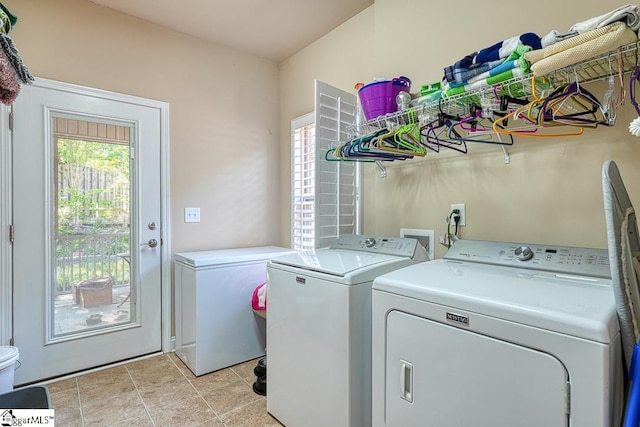 washroom with washer and dryer and light tile patterned floors