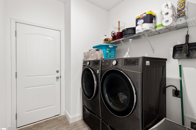 washroom featuring hardwood / wood-style flooring and independent washer and dryer