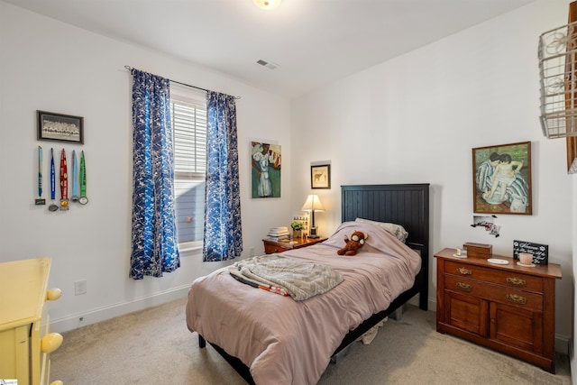 bedroom featuring light carpet