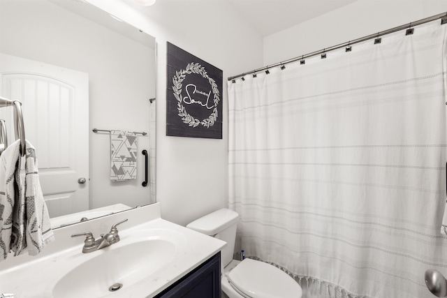 bathroom featuring toilet and vanity