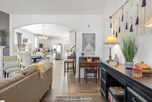 living room with a chandelier and wood-type flooring