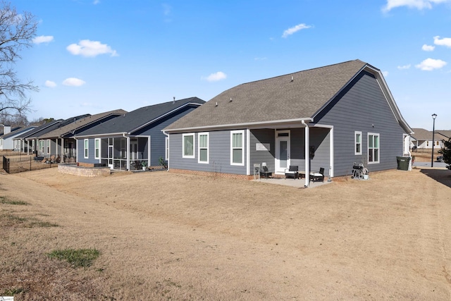 rear view of house featuring a patio and a sunroom