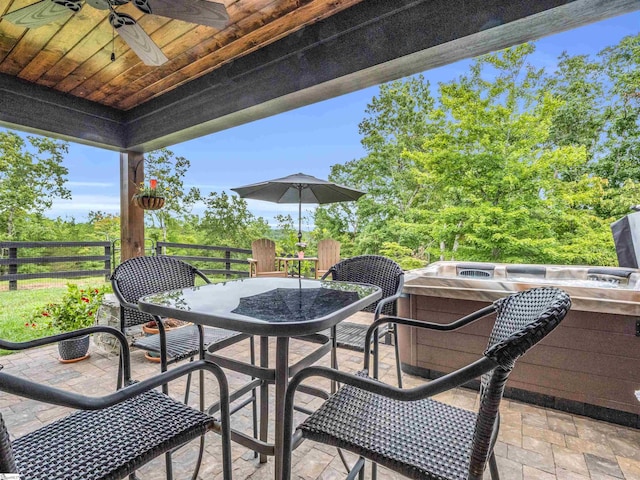 view of patio / terrace featuring ceiling fan and a hot tub