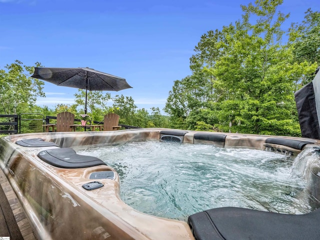 view of pool with a hot tub