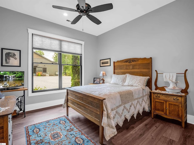 bedroom featuring ceiling fan and dark hardwood / wood-style floors