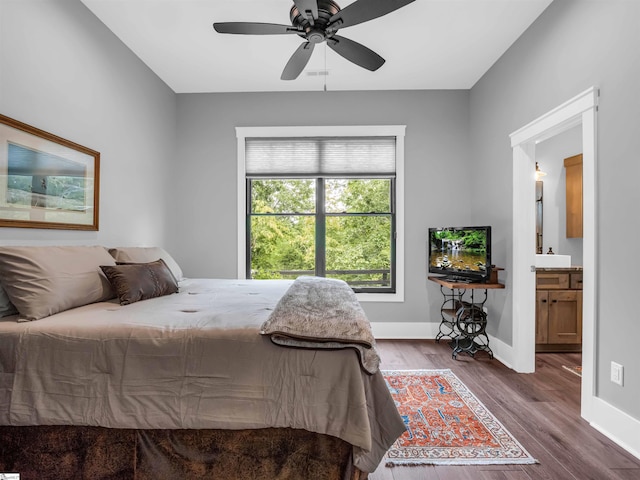 bedroom featuring ensuite bathroom, ceiling fan, and dark hardwood / wood-style floors