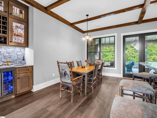 dining room with dark hardwood / wood-style flooring, beverage cooler, wet bar, and beam ceiling