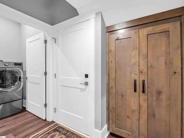 laundry area with hardwood / wood-style flooring and washer / clothes dryer