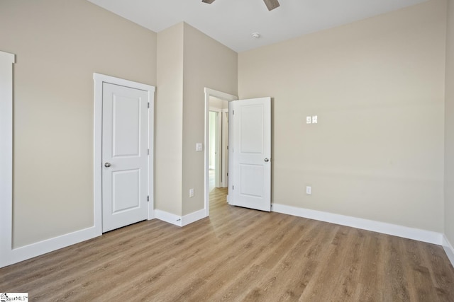 unfurnished bedroom with ceiling fan and light hardwood / wood-style flooring