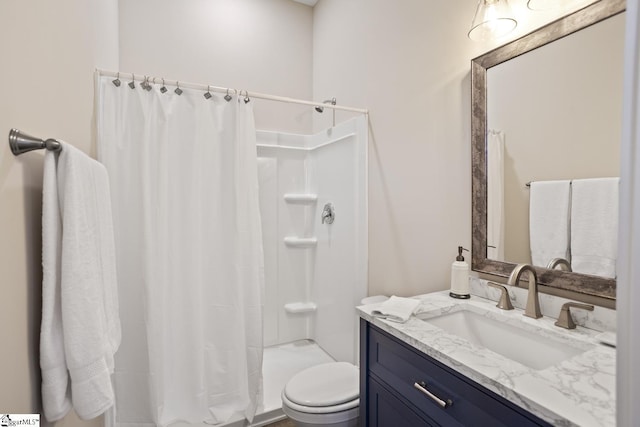 bathroom featuring toilet, walk in shower, and vanity