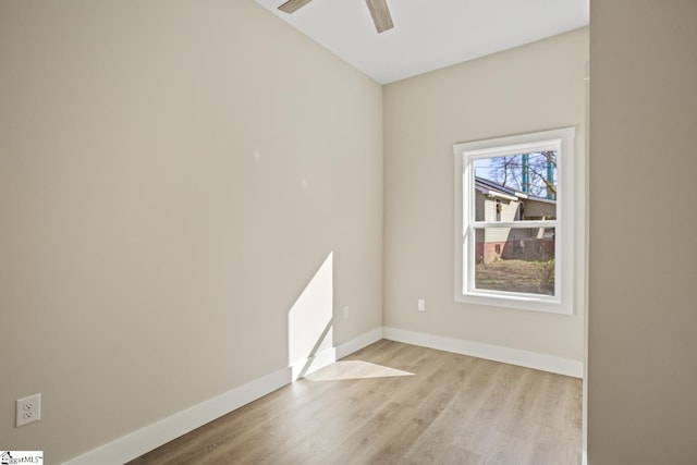 empty room with ceiling fan and light hardwood / wood-style flooring