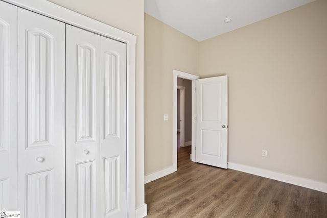 unfurnished bedroom with a closet and wood-type flooring