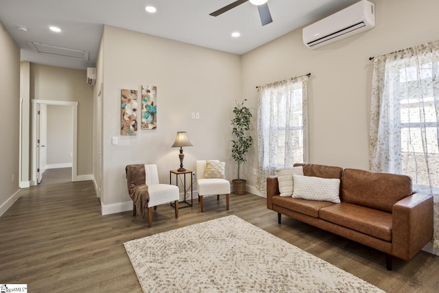 living area with ceiling fan, dark hardwood / wood-style floors, and a wall unit AC