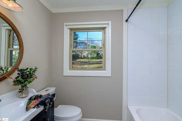 bathroom featuring tiled shower / bath combo and toilet