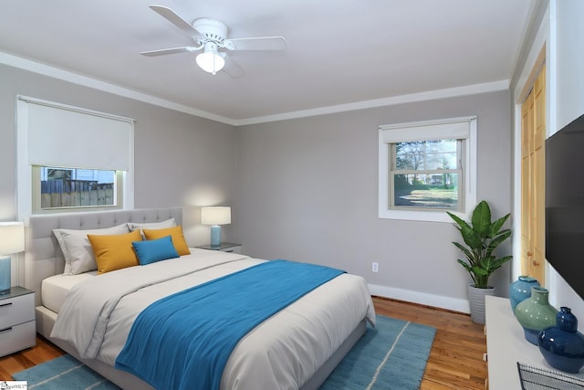 bedroom featuring ceiling fan, crown molding, a closet, and hardwood / wood-style floors