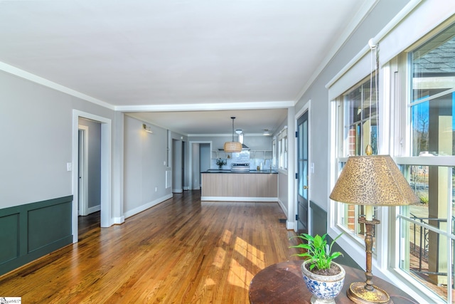 unfurnished living room with crown molding and dark hardwood / wood-style floors