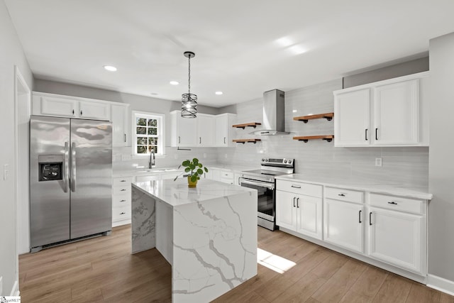 kitchen with white cabinets, stainless steel appliances, and island range hood