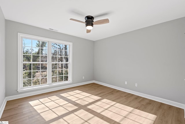 unfurnished room featuring light hardwood / wood-style floors, ceiling fan, and a healthy amount of sunlight