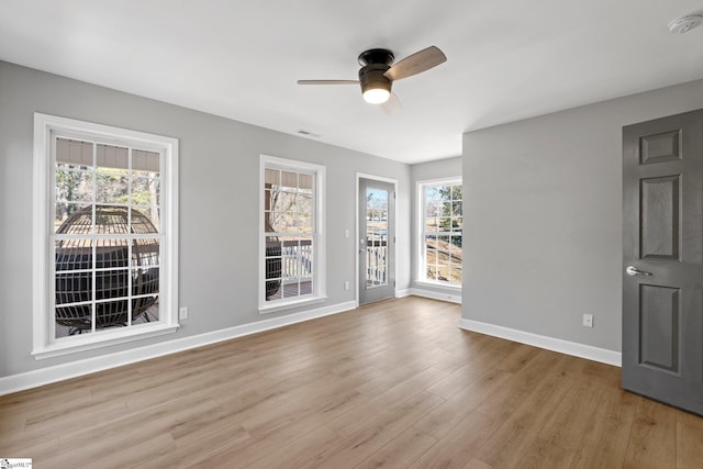 spare room featuring ceiling fan and light hardwood / wood-style flooring