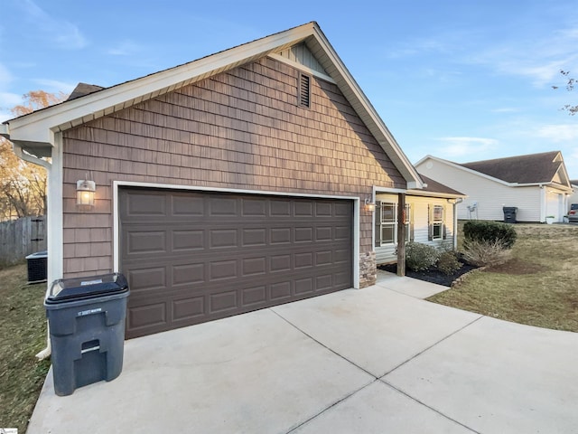 view of front of property with central AC unit and a garage