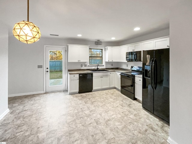 kitchen featuring black appliances, pendant lighting, white cabinetry, and sink