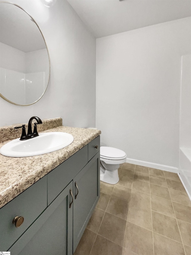 bathroom featuring toilet, vanity, and tile patterned floors