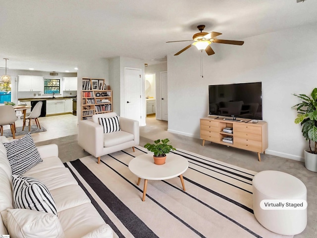 living room featuring sink and ceiling fan