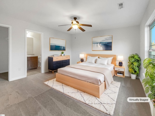 carpeted bedroom with connected bathroom and ceiling fan